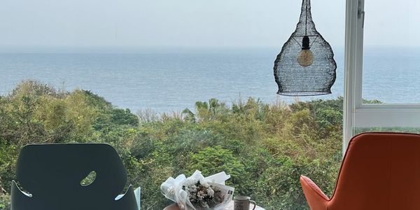 A serene landscape view from a window next to a practice space.